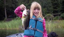 young girl showing fish she caught